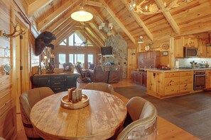 A spacious wooden interior with a dining area, kitchen, and living space. - Mountain Top Lodge With Amazing Vista (Jasper)