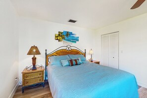 A bedroom with a bed, two bedside tables, a wall art piece, and a closet. - < 1 Mi to Beach! Top-floor Naples Retreat w/ Pool (Naples)