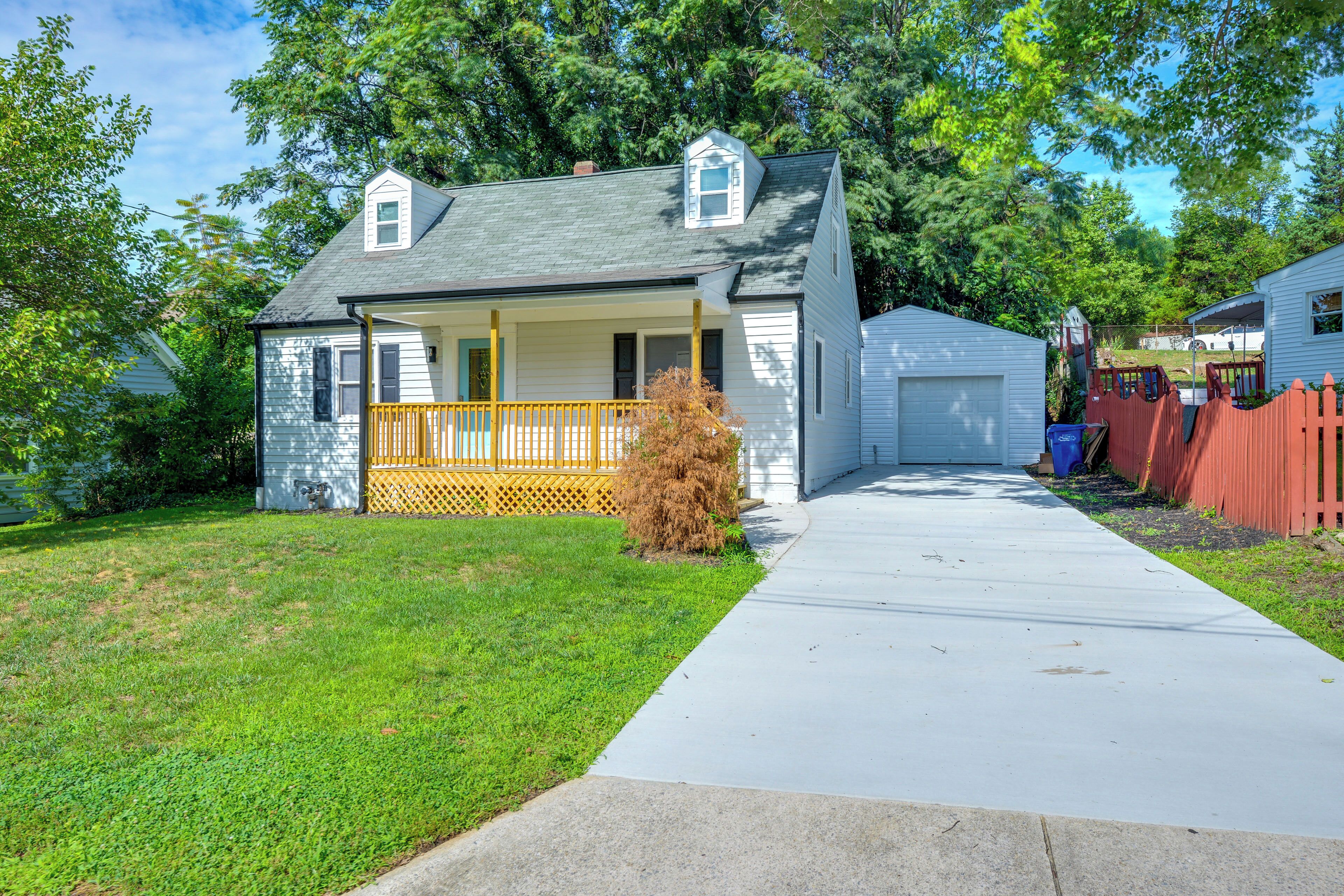 A single-story house with a front porch, a garage, and a well-maintained lawn.