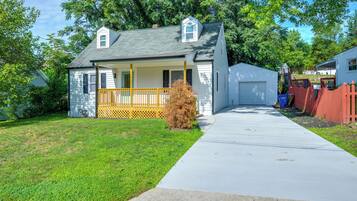 A single-story house with a front porch, a garage, and a well-maintained lawn.