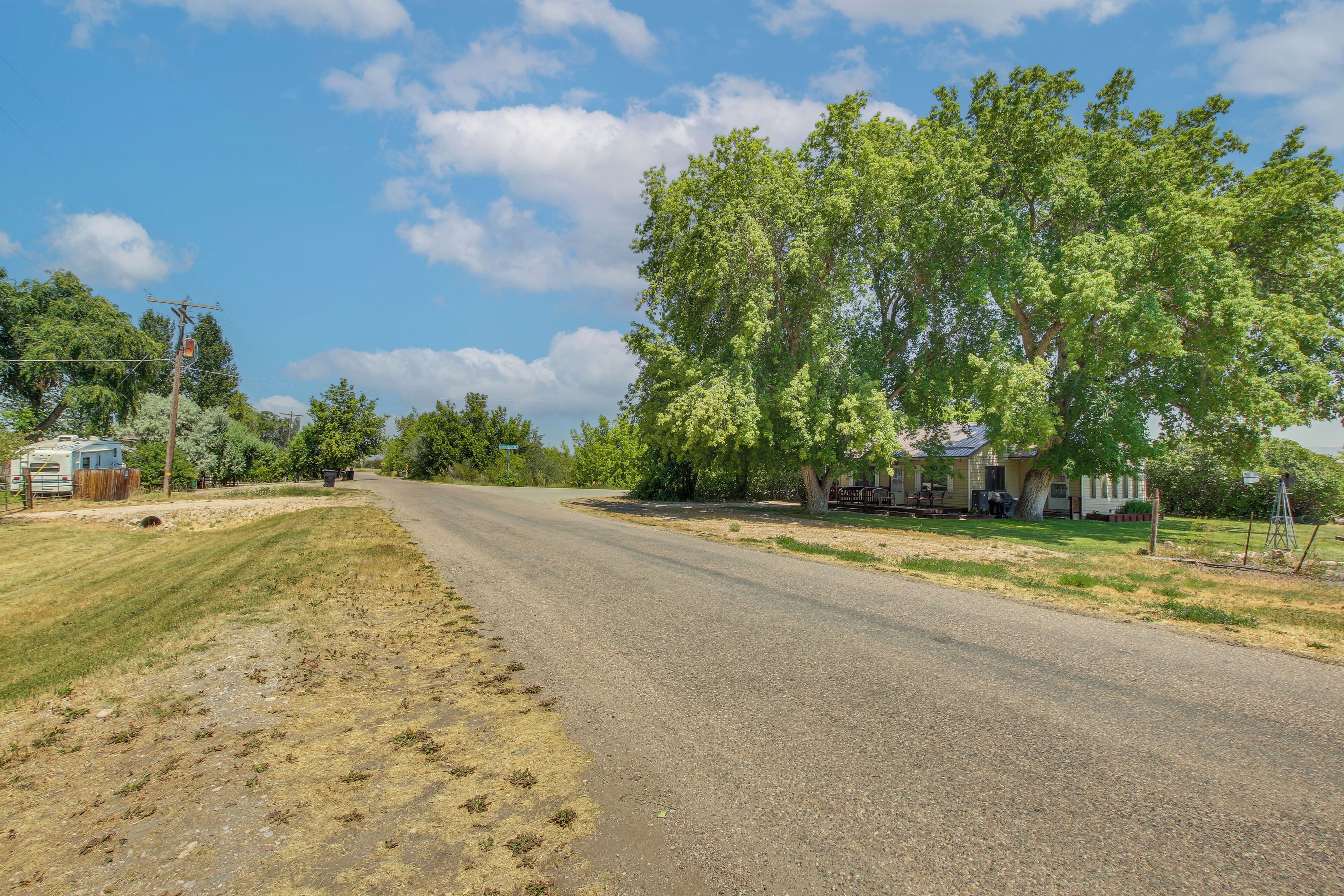 A rural road with houses on one side and a trailer park on the other.