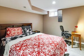 A bedroom with a large bed, a desk, and a chair. - Hike, Golf & Relax! Basement Apt in Hagerstown (Hagerstown)