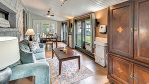 A spacious living room with a fireplace, a ceiling fan, and a large window. - Hike, Fish & Explore! Family Getaway in Elberton (Elberton)