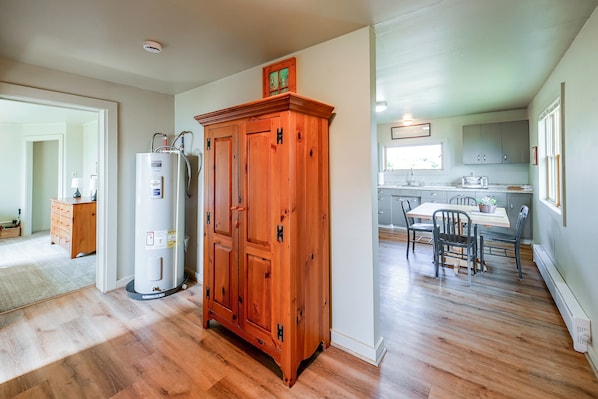 A spacious kitchen with wooden cabinets, a built-in refrigerator, and a dining area with a table and chairs. - Stillwater River Cabin: Private Access to Fishing (Absarokee)