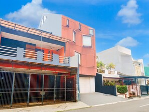 A modern building with a flat roof, a balcony, and a gated entrance. - Luxury Deluxe DBL Retreat W/ Free Wifi and Parking (Jakarta)