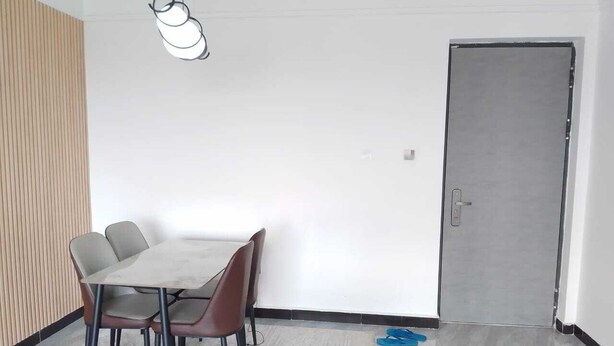 A conference room with a table and chairs, a door, and a wall with vertical lines. - Staroot - The Velvet Stay (Nairobi)