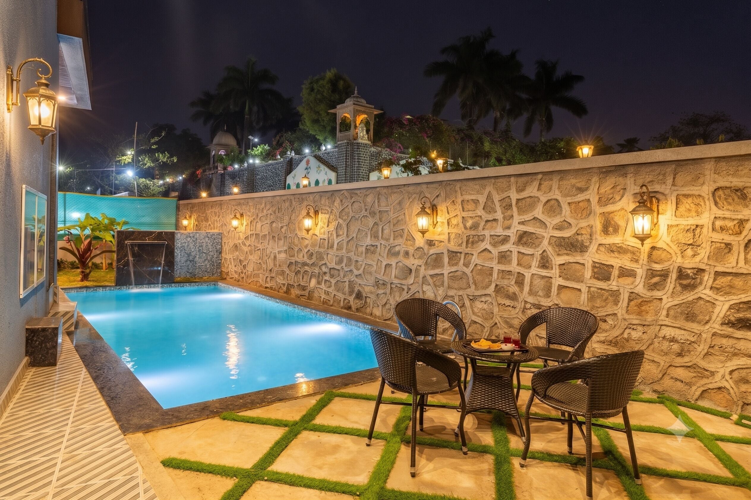 Piscina con muros de piedra y zona de estar al aire libre.