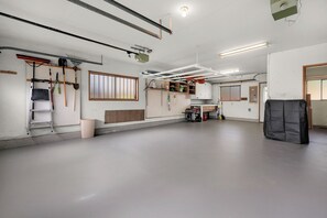 A spacious room with a pegboard wall, a window, and a door. - THAT'S WHAT SEA SAID at Seaside Beach (Seaside)