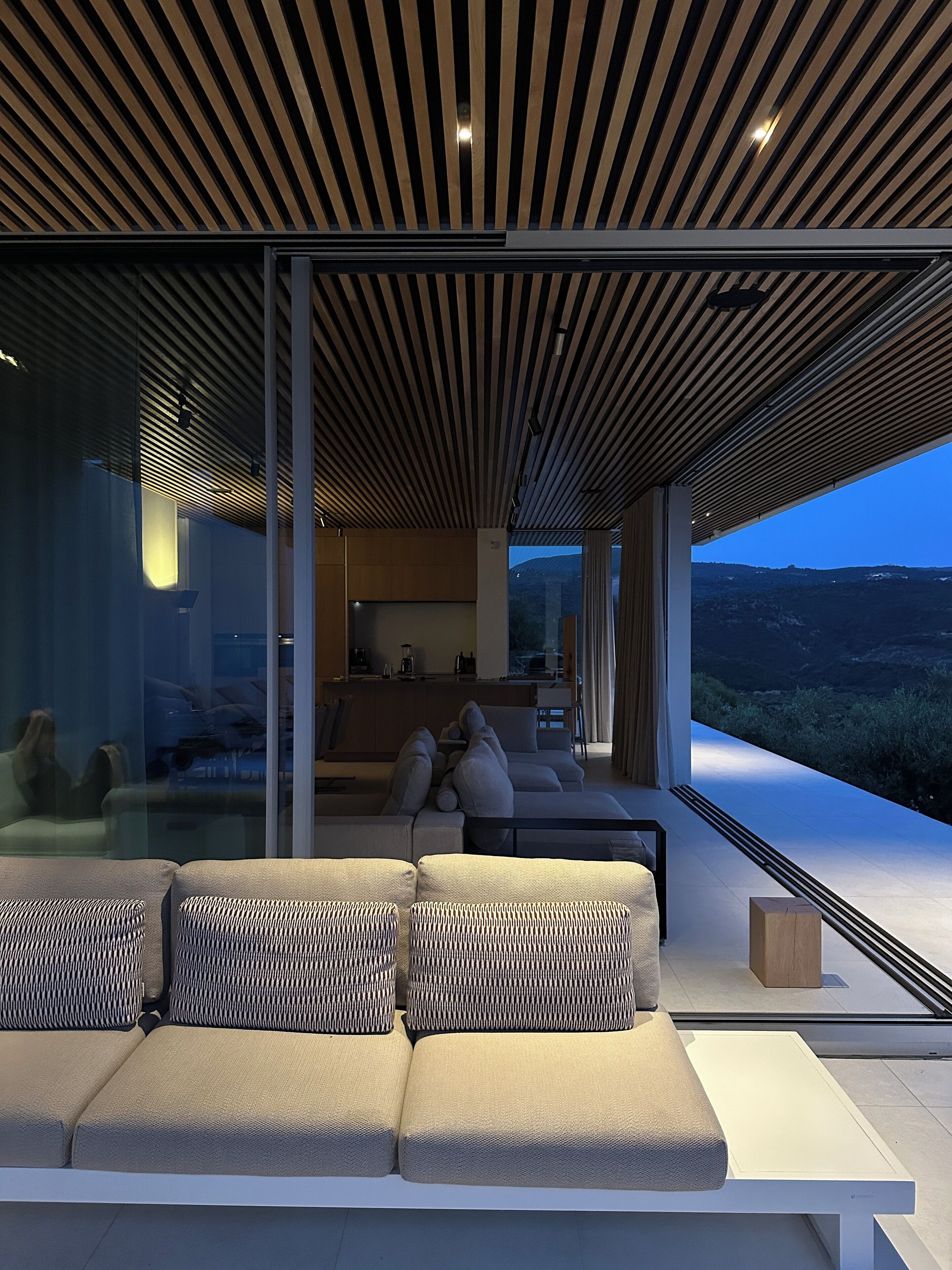 A modern living room with a sofa and a dining area.