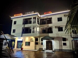 A multi-story hotel with a prominent sign reading 'GROUPS FOKAN HOTEL' at the top.