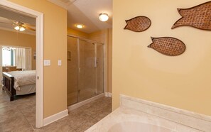 A bathroom with a shower, a bathtub, and a toilet. - Phoenix West 2702 3 Bedroom Condo (Orange Beach)