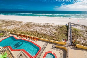 A beachside pool with a lifeguard stand, a sandy beach, and a clear view of the ocean. - Phoenix Iii 3055 1 Bedroom Condo (Orange Beach)