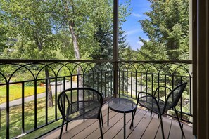 A balcony with a metal railing, two chairs, and a small table. - Ski-In/Out Beaver Creek Condo w/Amenities (Beaver Creek)