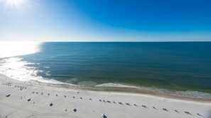 A beach with a clear sky and calm sea. - Phoenix West 2506 3 Bedroom Condo (Orange Beach)
