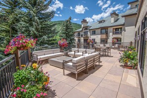 A patio area with outdoor seating and flower planters.