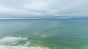 A coastal view with calm sea and overcast sky. - Phoenix West 2603 3 Bedroom Condo (Orange Beach)