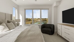 Ein modernes Schlafzimmer mit einem großen Bett, einem Sessel, einem Fernseher und Blick auf einen Pool und die Landschaft.