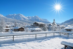A snow-covered village with traditional buildings, a prominent church, and a mountain backdrop. - Premium Apartment # C1 with 3 bedrooms and wellness area (Söll)