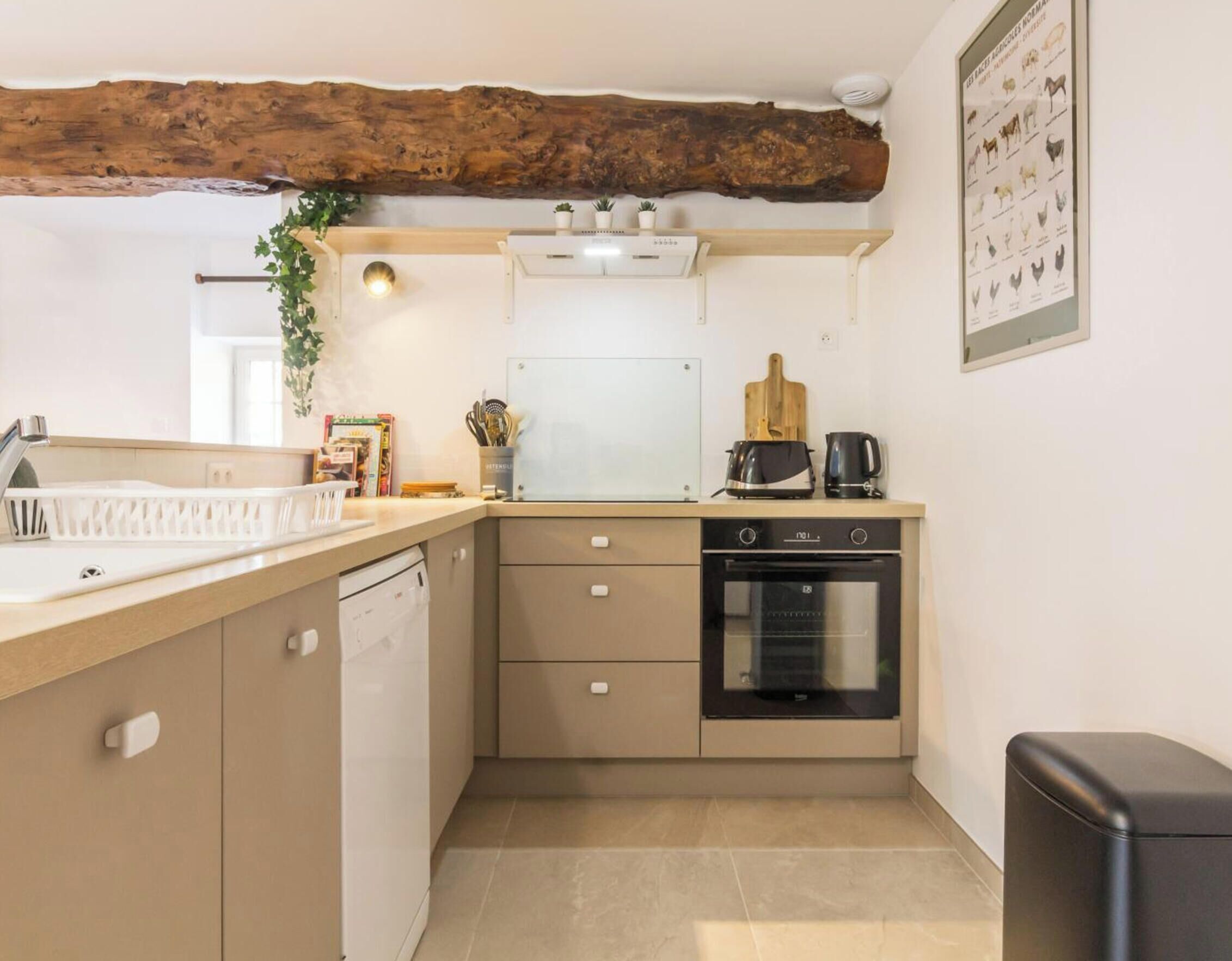 A compact kitchen with a built-in dishwasher, a stove, and a microwave.