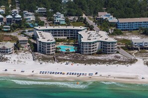 A coastal hotel with multiple buildings, a beachfront, and a swimming pool. - 2BR Gulf-Front | Pool, Hot Tub & Direct Beach Access + Attraction Tickets! (Santa Rosa Beach)
