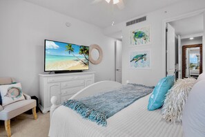 A bedroom with a bed, a television, a dresser, and artwork on the wall. - Sister’s Paradise by AMI Locals (Bradenton)
