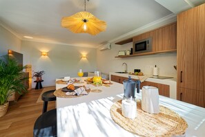 A modern kitchen with wooden cabinets, a microwave, and a coffee maker on the counter. - Villa Catalina, just a short walk from the beach in San Agustín (San Bartolomé de Tirajana)