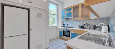 A modern kitchen with a built-in oven, a sink, and cabinets.