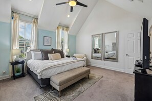 A bedroom with a bed, bedside tables, a bench, a large mirror, and a ceiling fan. - Spacious Nashville townhouse w/ exclusive backyard (Nashville)