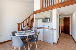 A modern kitchen with a built-in microwave, a coffee maker, and a sink. - Kent Coast Stays (Birchington-on-Sea)