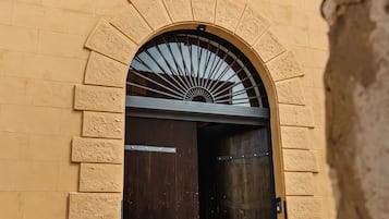 Una entrada de edificio con un arco grande y un letrero encima.