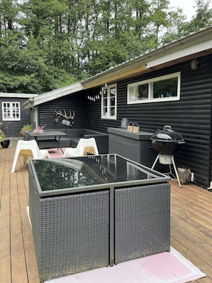 A deck with outdoor furniture, a grill, and a glass-top table. - Stay in" Sandersvig delight" filled with colours (Haderslev)
