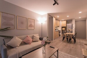 Ein modernes Wohnzimmer mit Sofa, Couchtisch und einem Bild an der Wand.