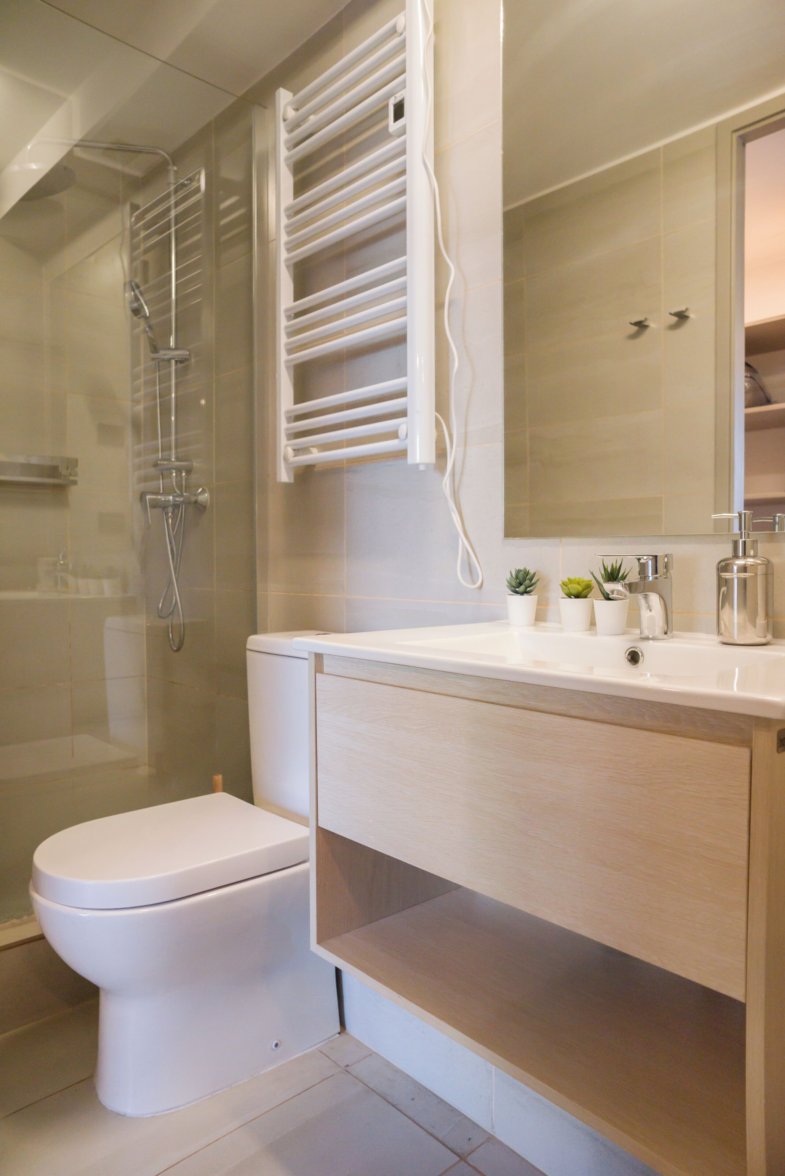 Un baño moderno con inodoro, ducha y tocador.