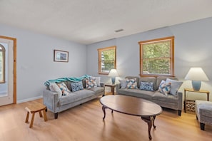 A living room with two grey sofas, a round coffee table, and two side tables with lamps. - SH30: Southern Shores 30 (Southern Shores)