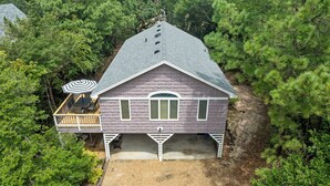A two-story house with a covered patio and a garage. - SH30: Southern Shores 30 (Southern Shores)