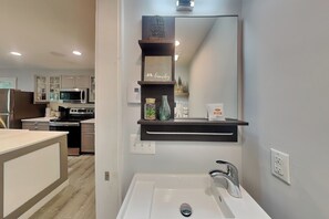 A modern kitchen with a built-in microwave, stove, and cabinets. - Winter Green Lodge (McHenry)