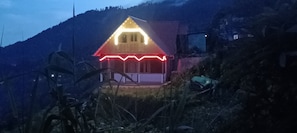 A house with a sloped roof and a porch.
