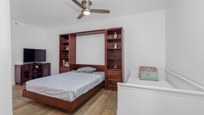 A bedroom with a bed, a television, a wardrobe, and a ceiling fan. - Station Square Condominiums – Spacious Downtown Clearwater Retreat with Resort-Style Amenities (Clearwater)