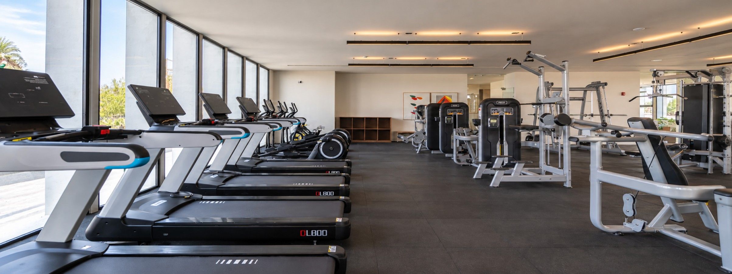 A gym with treadmills, weight machines, and exercise equipment.