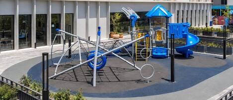 A playground with swings, slides, and climbing structures.