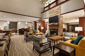 A spacious lobby with a fireplace, comfortable seating, and a television. - 1 Qn Studio w/ Kitchen | Free Breakfast & Pool (Tampa)