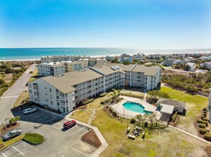 A multi-story hotel with a swimming pool, parking lot, and ocean view. - 3BR Direct Ocean Front Condo @ The Point! Point Emerald Villas A209 (Emerald Isle)