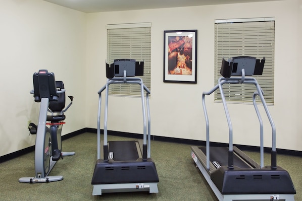 A fitness room with treadmills and a stationary bike.