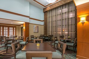 Spacious dining area with tables and comfortable seating.