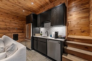 A compact kitchen with a refrigerator, sink, and coffee maker. - Hemlock Social: Creekside Paradise • Pool • Sauna • HotTub • FirePit • Fun Games (Blue Ridge)
