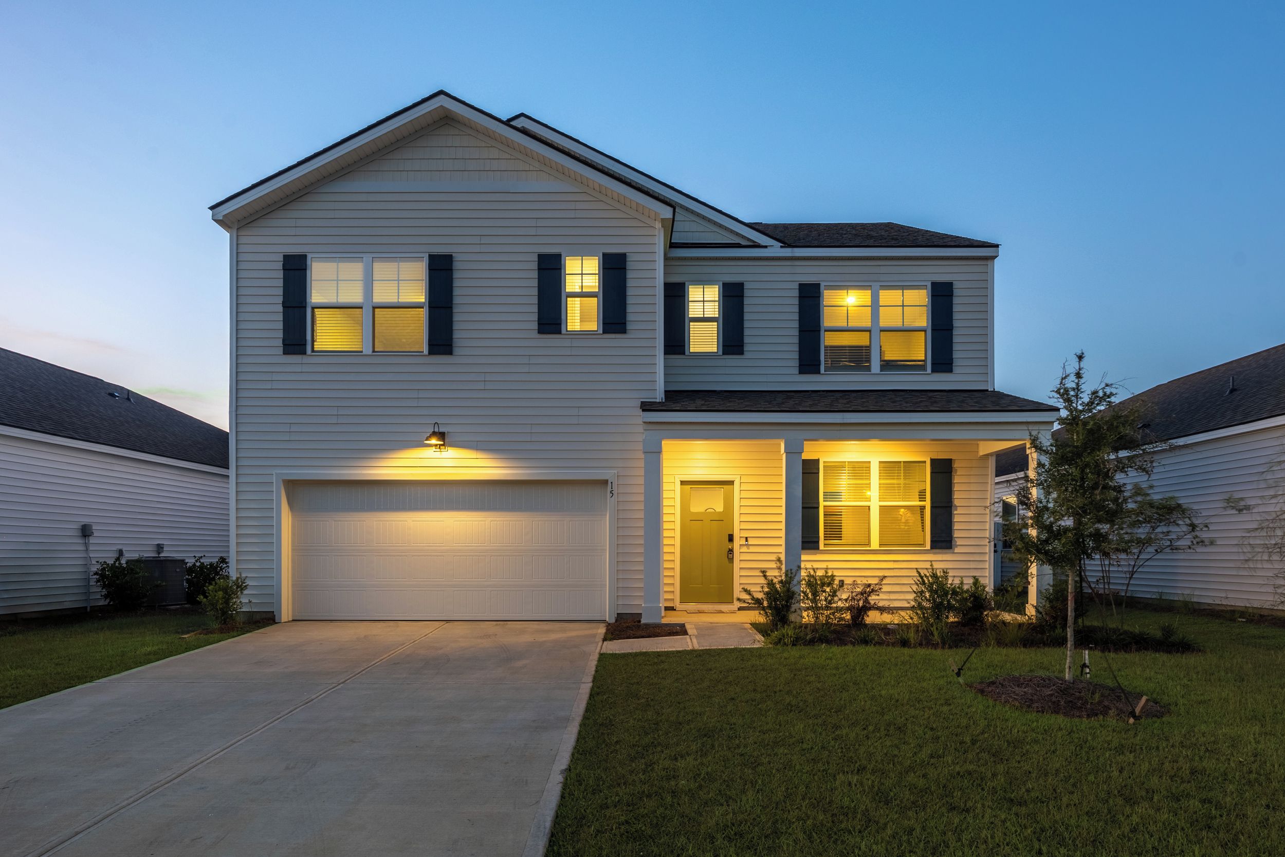 Home at dusk: two stories, two-car garage