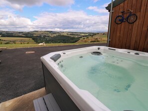 A hot tub with a view of a rural landscape. - The Stables (Halifax)