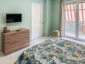 A bedroom with a bed, a dresser, a television, and a window with a view. - Karim's House - Portici (Portici)