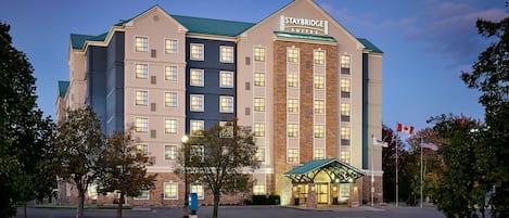 A Staybridge Suites hotel with a multi-story building, a covered entrance, and a parking lot.