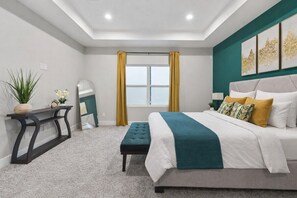 A bedroom with a bed, bedside table, and a window with curtains. - Designer 3BR w/ Fireplace, Yard & Free Parking (Houston)